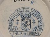a plate with a picture of a coat of arms and a crown on it