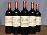 four bottles of wine are lined up on a table