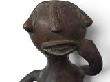 bronze figurine of a man with a hat on his head