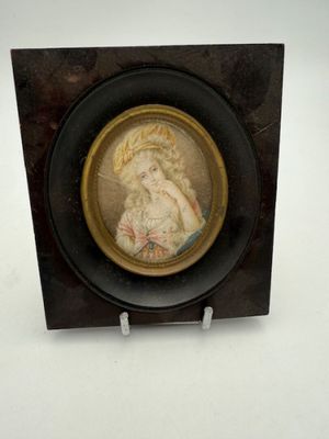 a picture of a woman in a hat on a plaque
