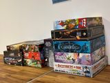 a lot of board games on the table in this room