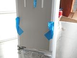 a refrigerator that is sitting on a pallet in a garage