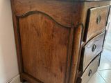 a wooden cabinet with a drawer on top of it