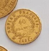 four different types of gold coins sitting on top of a white surface