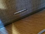 a close up of a speaker on a wooden table