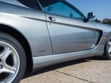 a silver sports car parked on the side of the road