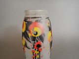 a vase with a painting on it sitting on a table