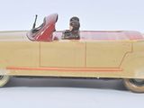 a yellow toy car with a man in the driver seat
