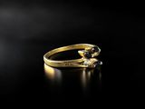 a close up of a gold ring on a black surface