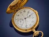 an antique pocket watch with a gold case sitting on a blue surface