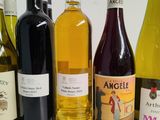 several bottles of wine are lined up on a table