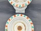 two white vases with colorful designs on them