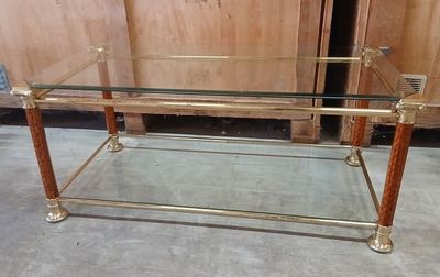 a glass table with a gold frame on it