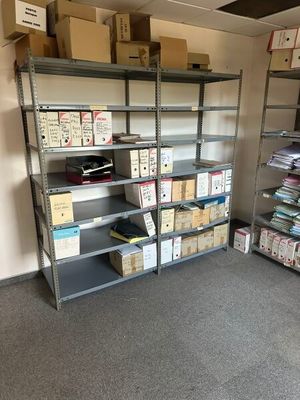 many boxes and boxes on the shelves in the room