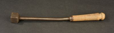 a close up of a wooden handle on a black surface