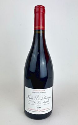 the bottle of red wine is sitting on the table