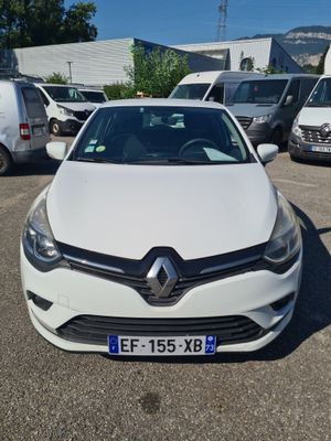 the white car is parked in the parking lot near other cars