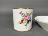 a white cup with a floral design on it