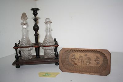 three glass vases sitting on a table next to a wooden plaque