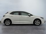 the white toyota corollant is parked in a large room