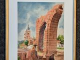 aquarelle encadrée représentant une arche avec une église en arrière-plan