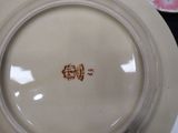 a white plate with a brown design on it