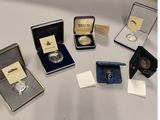 several different types of silver coins are on display on a table