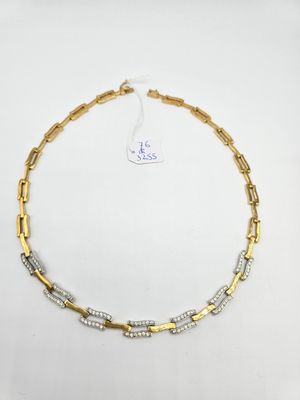 a gold and silver necklace on a white background