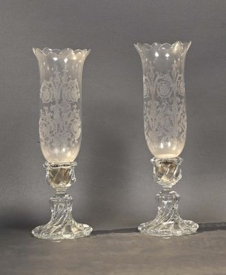 pair of clear glass vases sitting on top of a table