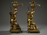 pair of antique brass candlesticks with figures on stands