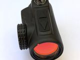 a close up of a black binoculars with a red lens