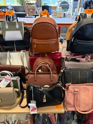 a lot of purses on a table in a store