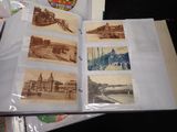 a lot of old postcards sitting on a table