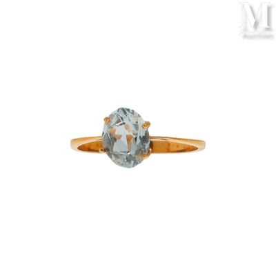 Gros plan sur une bague en or ornée d'une topaze bleue