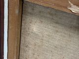 a cat that is sitting on the floor next to a door
