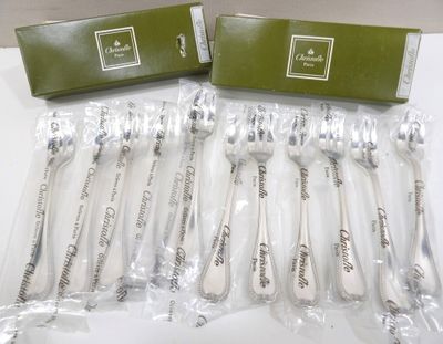 six cuillères à table dans des sachets en plastique, posées sur une surface blanche