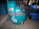 an image of a blue vacuum cleaner sitting on top of a floor next to a blue trash can