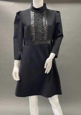 a mannequin wearing a black dress and black shoes