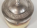 a silver container with a lid sitting on a table
