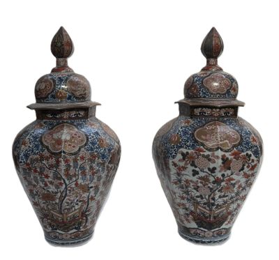 pair of asian style vases with lids on a white background