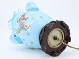 a blue fish shaped lamp with a clock attached to it