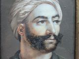 portrait of a man with a mustache and a turban in a gold frame