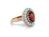 an image of a ring with a garnetite and diamonds