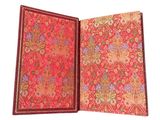 an open red book with a floral design on it