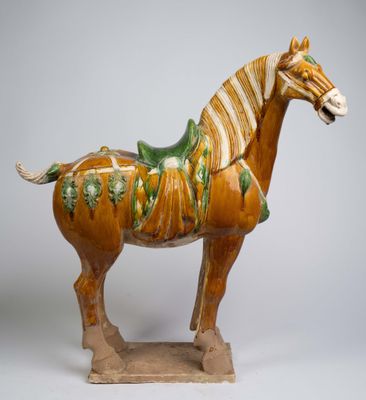 a statue of a horse with a saddle on it ' s back