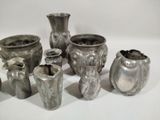 a lot of vases that are sitting on a table