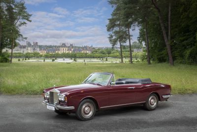 a red convertible car parked on the side of the road