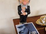 a figurine of a man on a table next to a book
