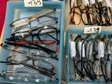 many pairs of glasses sitting in a blue box