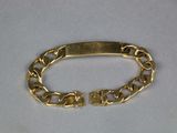 gold plated bracelet with a clasp on a white background